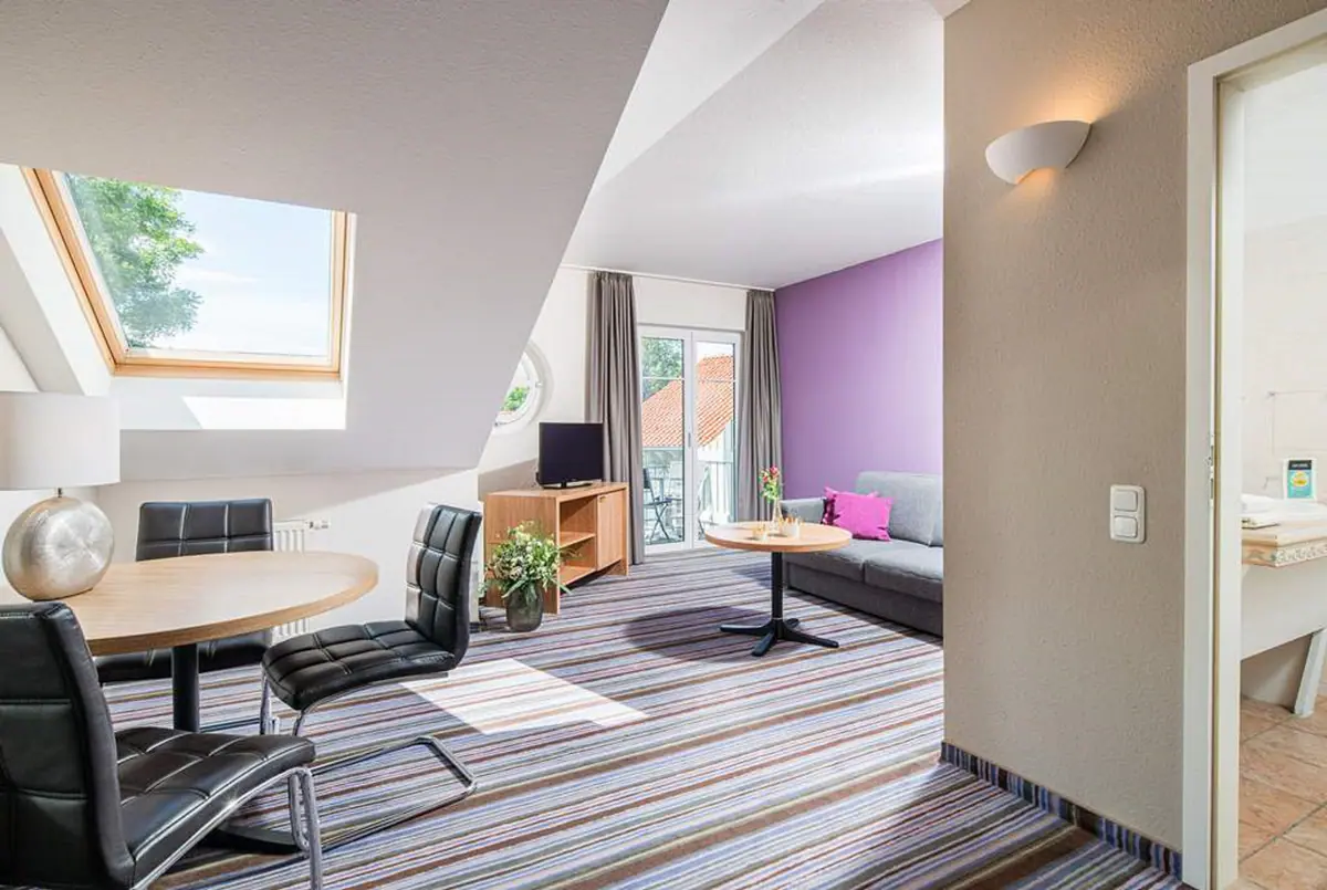 Appartement im Dachgeschoss mit Dachfenster und lila Wand